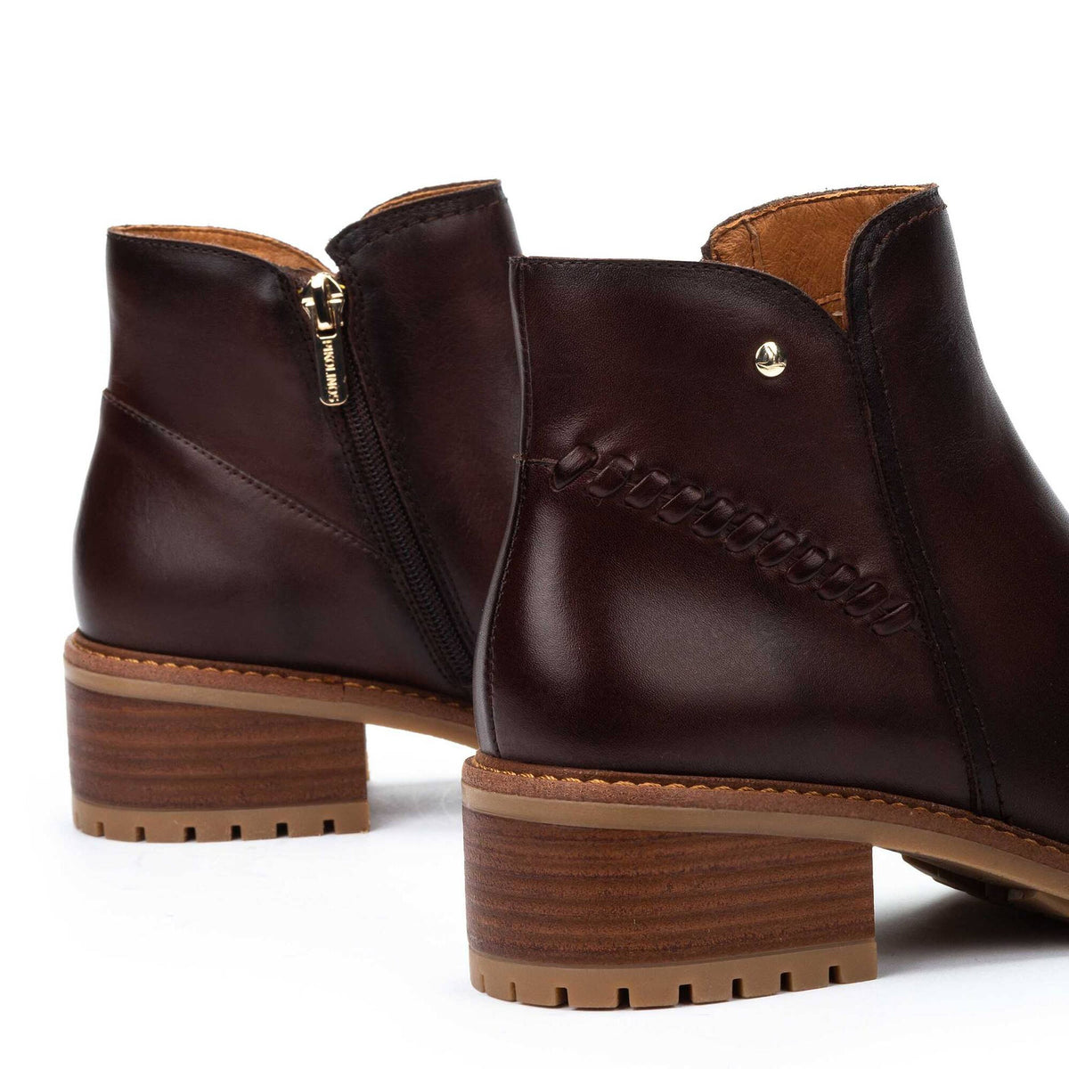 Brown leather ankle boots with a block heel on a white background