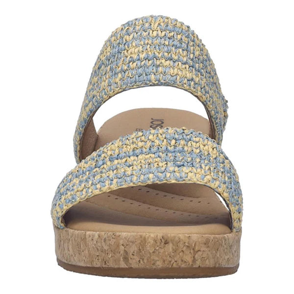 Blue and yellow woven sandal with cork sole on a white background