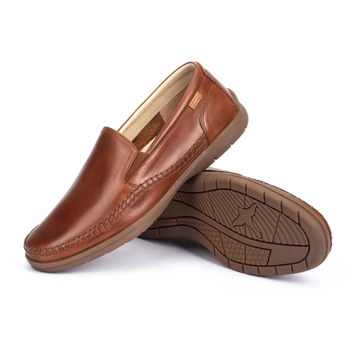 Brown leather loafers on a white background