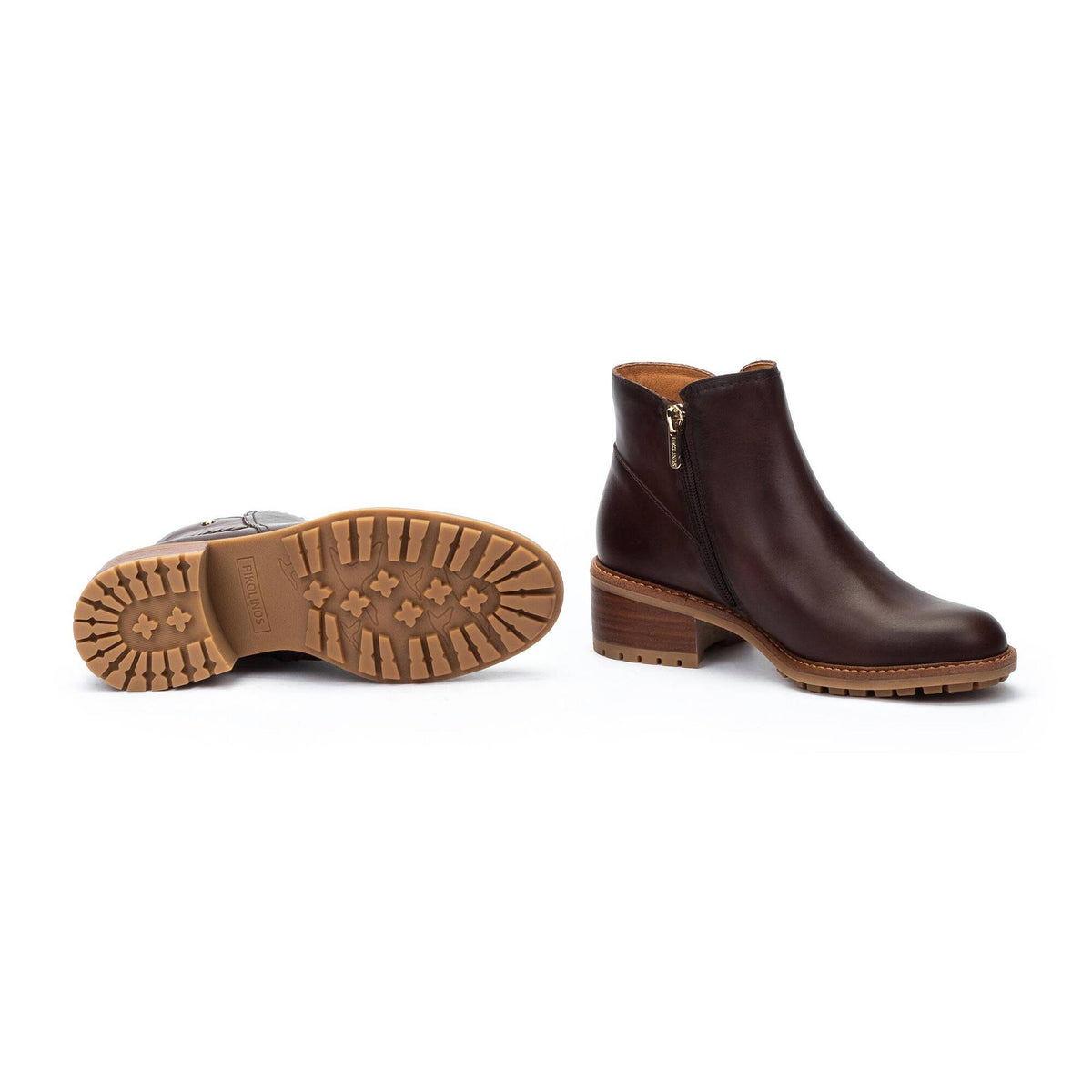 Brown leather ankle boot with a zipper on a white background
