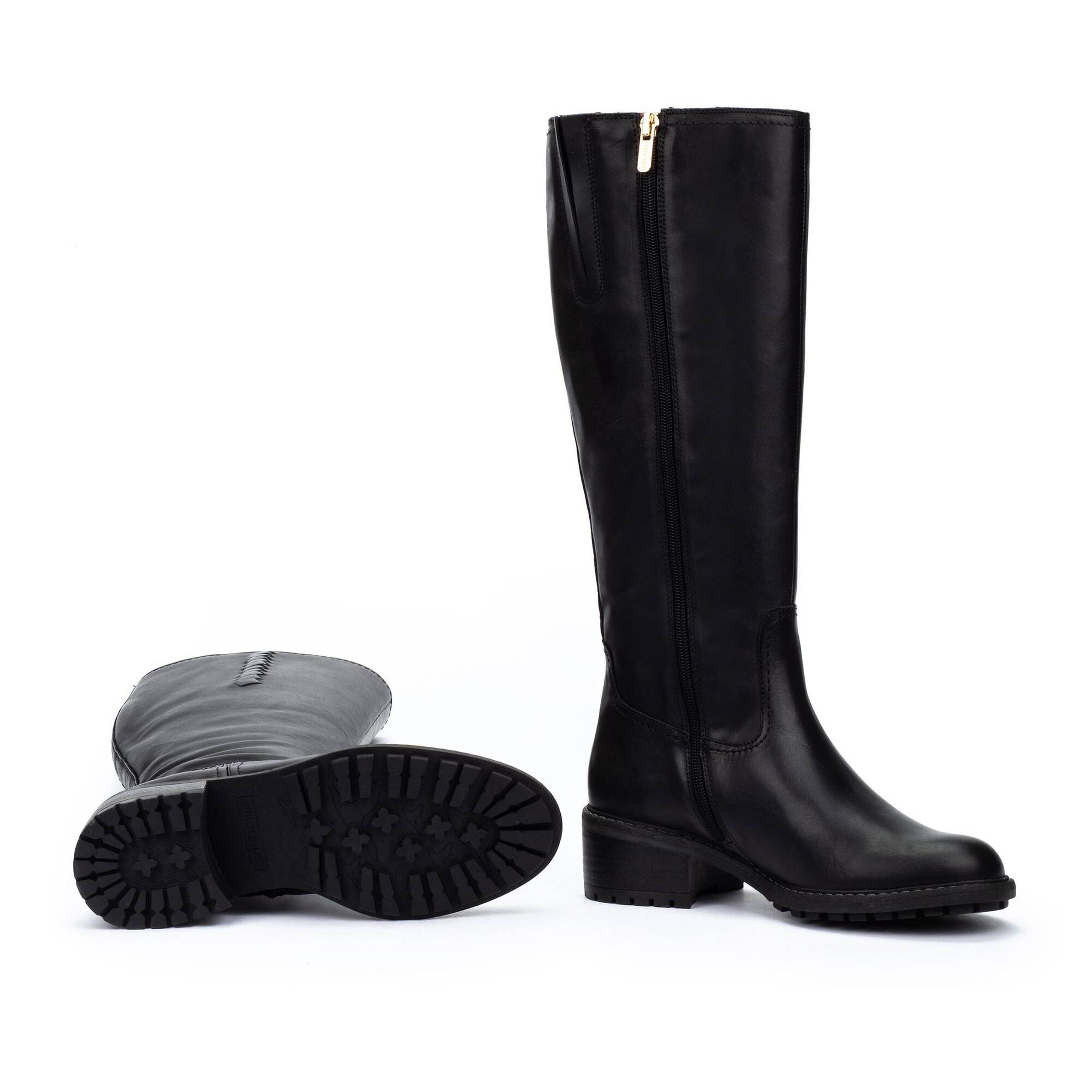 A pair of black knee-high leather boots with side zippers, shown on a white background with one boot standing upright and the other lying on its side to display the sole.