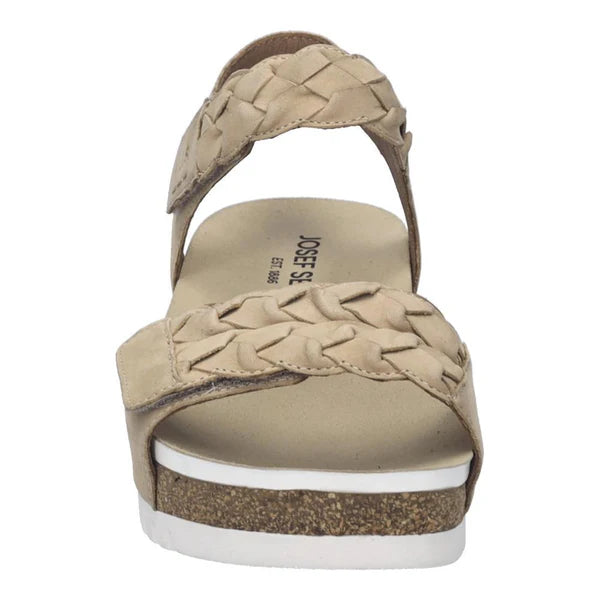 Beige sandal with braided design on a white background