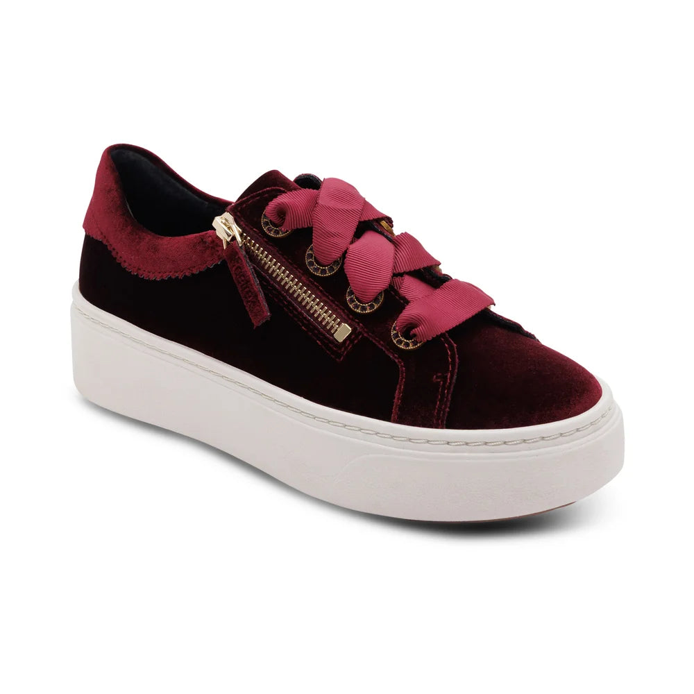 A low-top platform sneaker in deep burgundy velvet with a contrasting magenta-pink lace detail, a side zipper, and a thick white platform sole, shown on a white background.