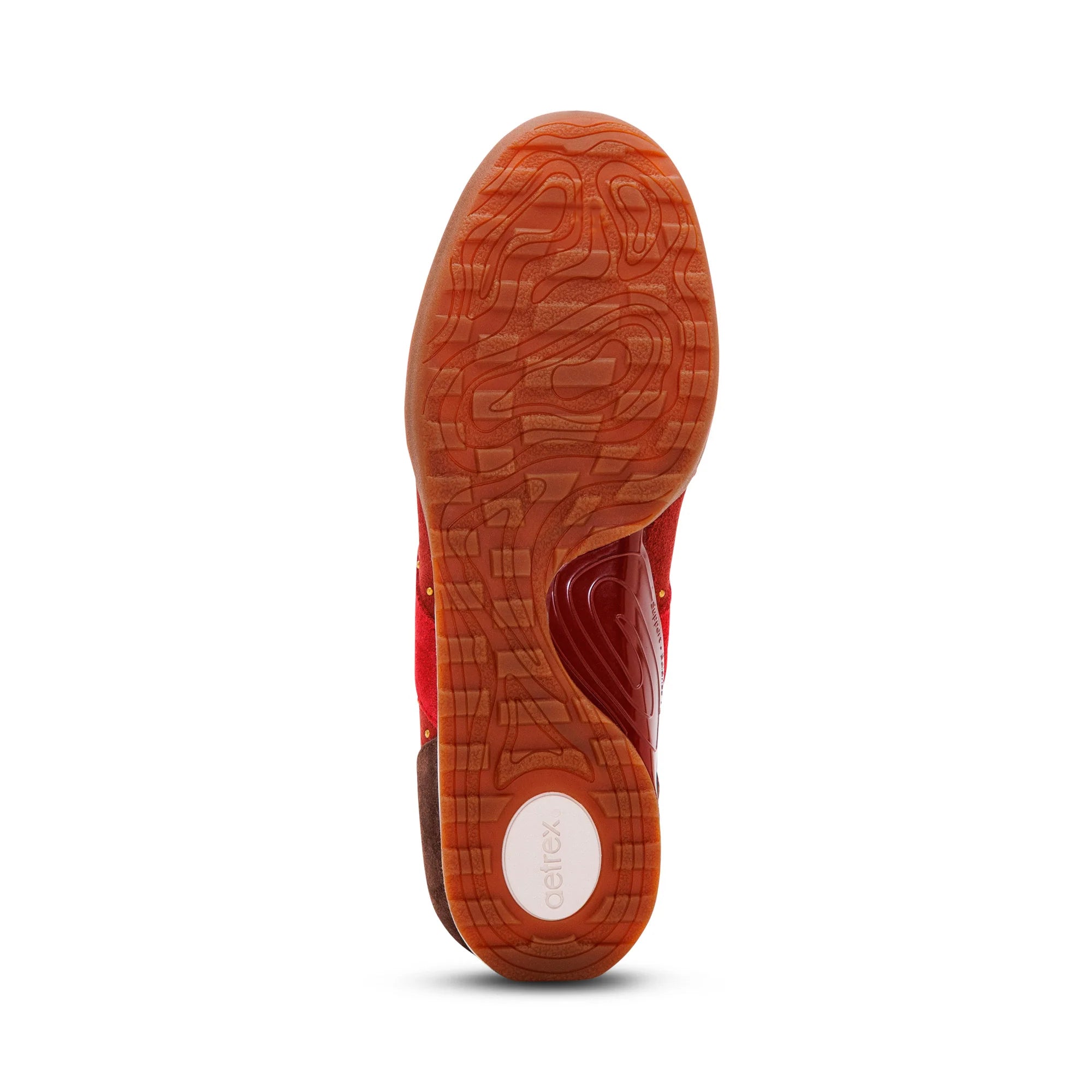 The textured orange-brown rubber outsole of a red athletic shoe, showing the Cheetex brand logo on the heel, isolated on a white background.