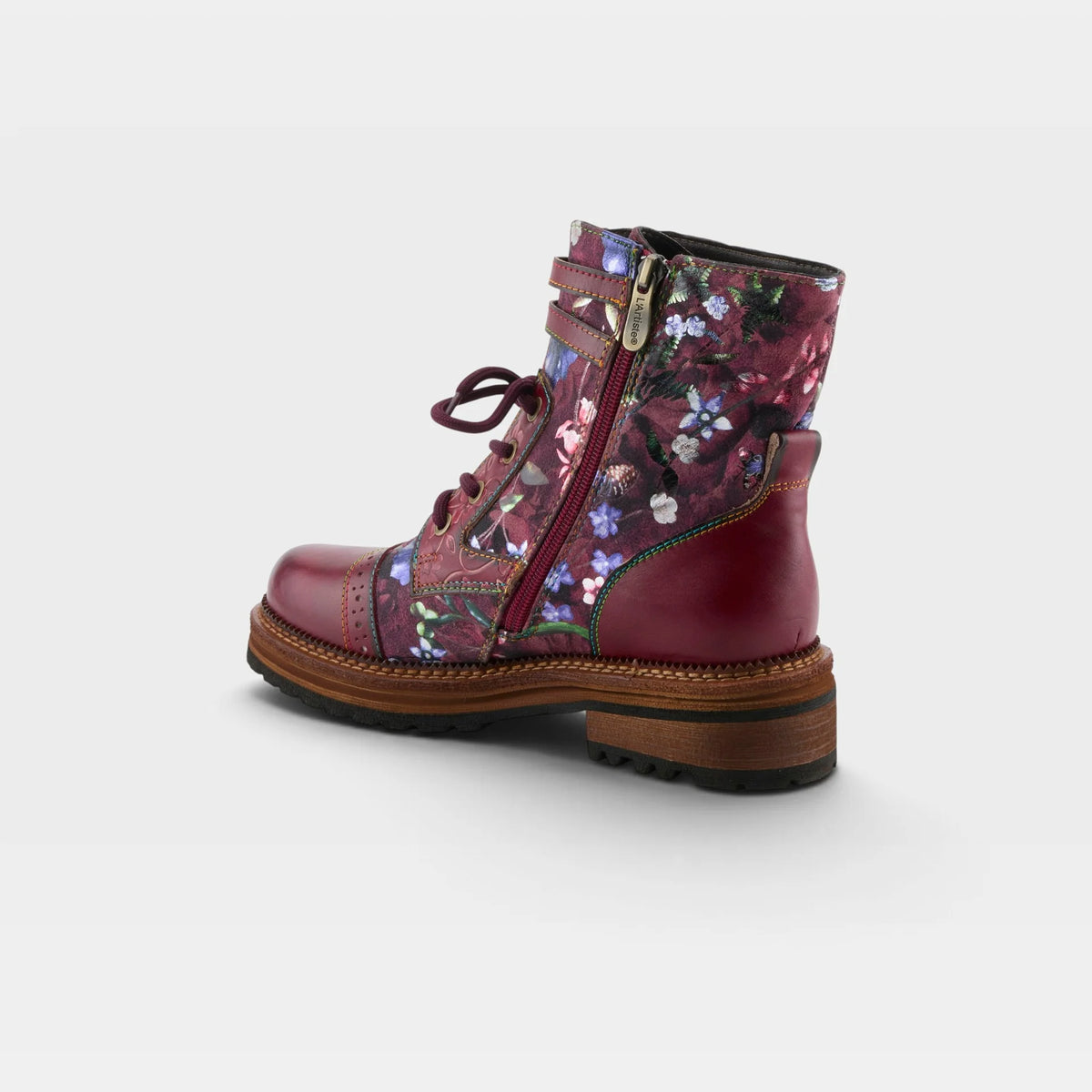 A single mid-calf lace-up boot with a floral print side panel and a solid burgundy leather heel, toe cap, and sole, shown from a three-quarters rear angle on a light gray background.