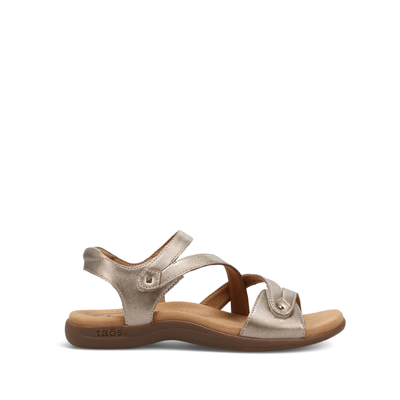 Gold sandal with a brown sole on a white background