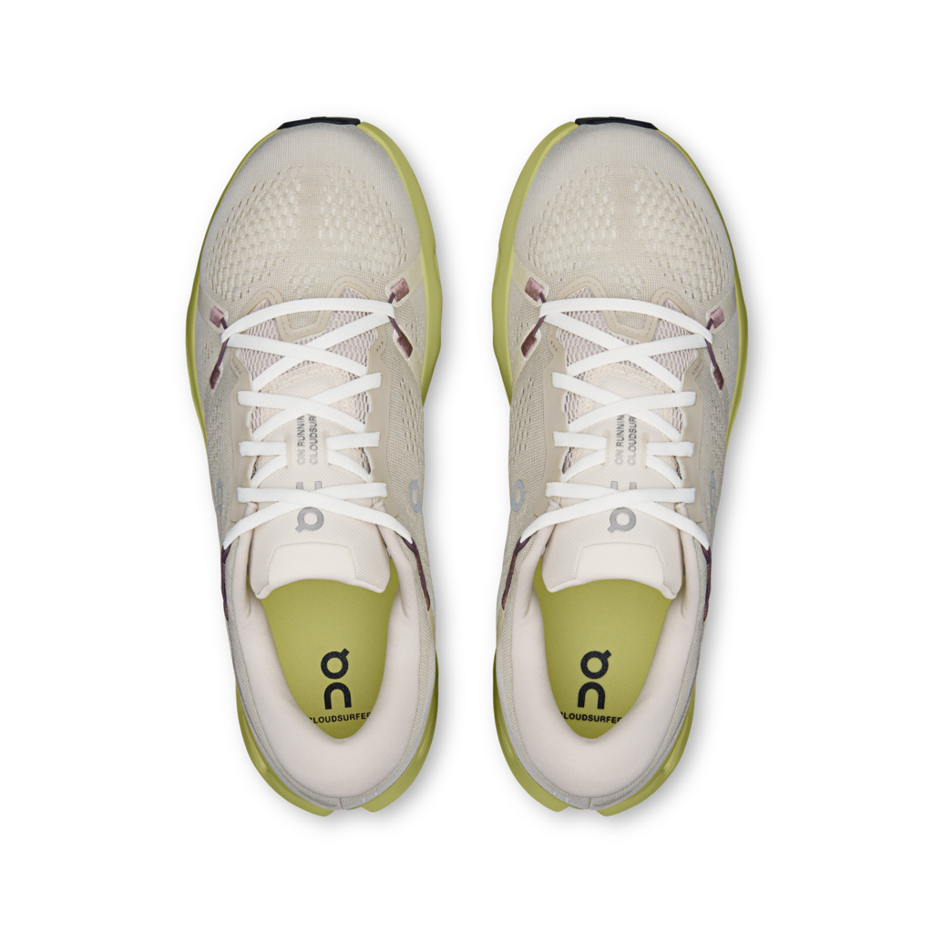 Pair of white running shoes with green accents on a transparent background