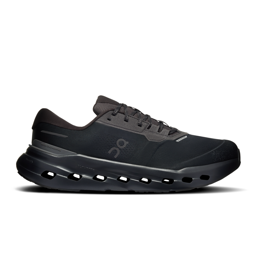 A black On running shoe with a thick, cushioned sole featuring circular cutouts, shown in a side profile on a white background.