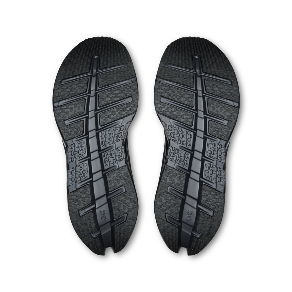 A pair of black athletic shoe soles shown from the bottom against a plain white background.