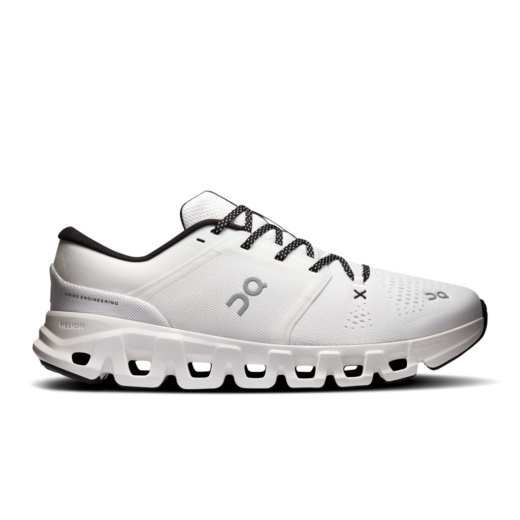 White athletic shoe with black laces on a white background