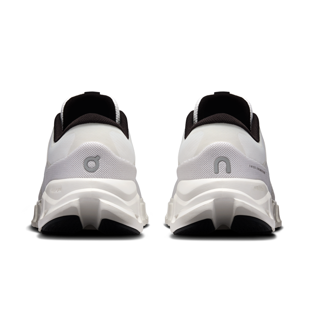 A pair of white and black sneakers shown from the back, featuring chunky white midsoles with black outsole sections and a gray logo on the heel.