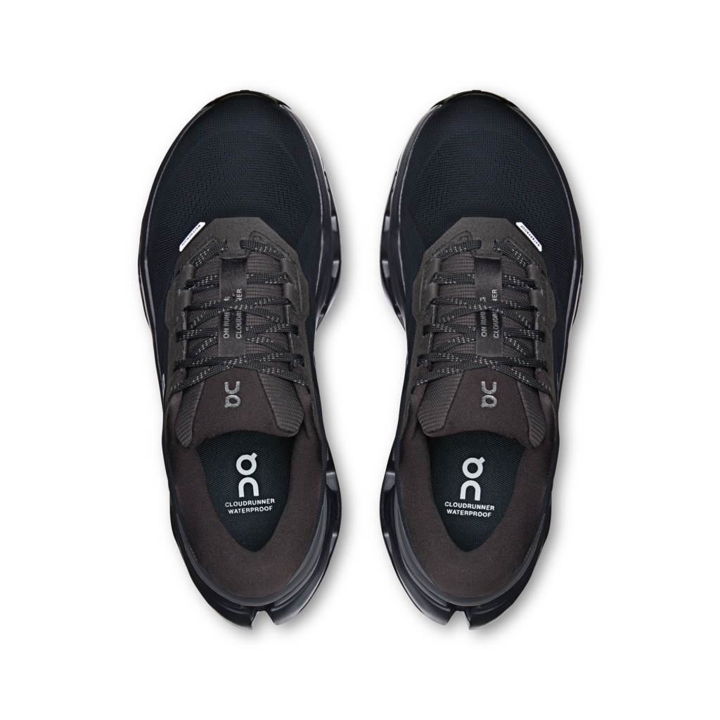 Pair of black running shoes with 'on' logo on a white background