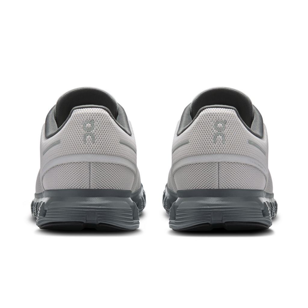 Gray athletic shoes with black soles on a white background