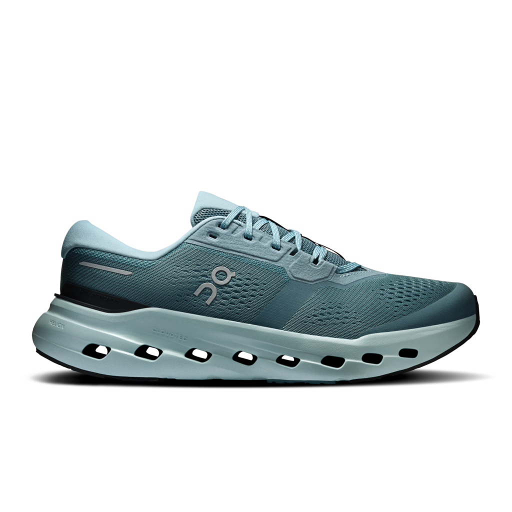 A single On running shoe in a muted teal-blue colorway, featuring a breathable mesh upper, a thick cushioned midsole with visible air holes, and the signature On logo on the side, set against a plain white background.