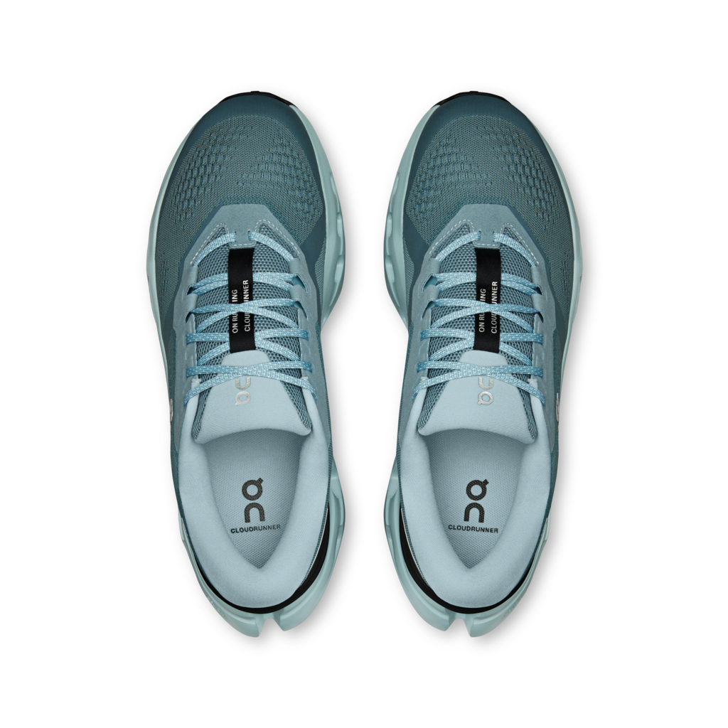 A pair of On running shoes in a dusty teal-blue colorway, shown from a top-down view on a clean white background.