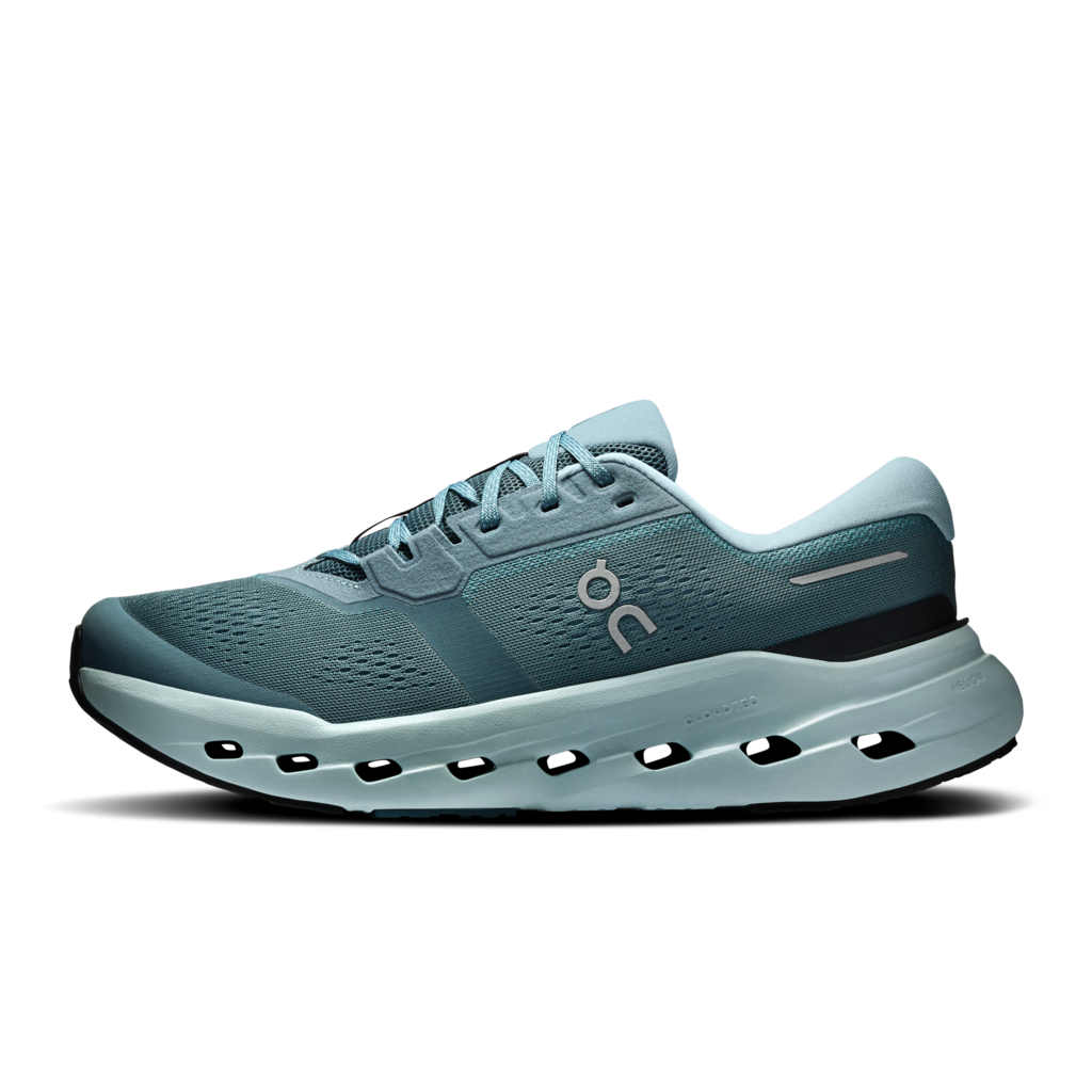 A single running shoe in a muted teal-blue colorway, shown in a clean side profile against a solid white background. The shoe features a breathable mesh upper, a thick, cushioned hollow-out sole, and the On logo on the side.