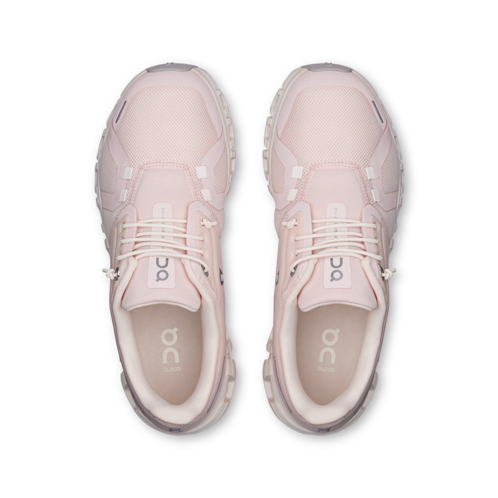 Pair of pink sneakers on a white background