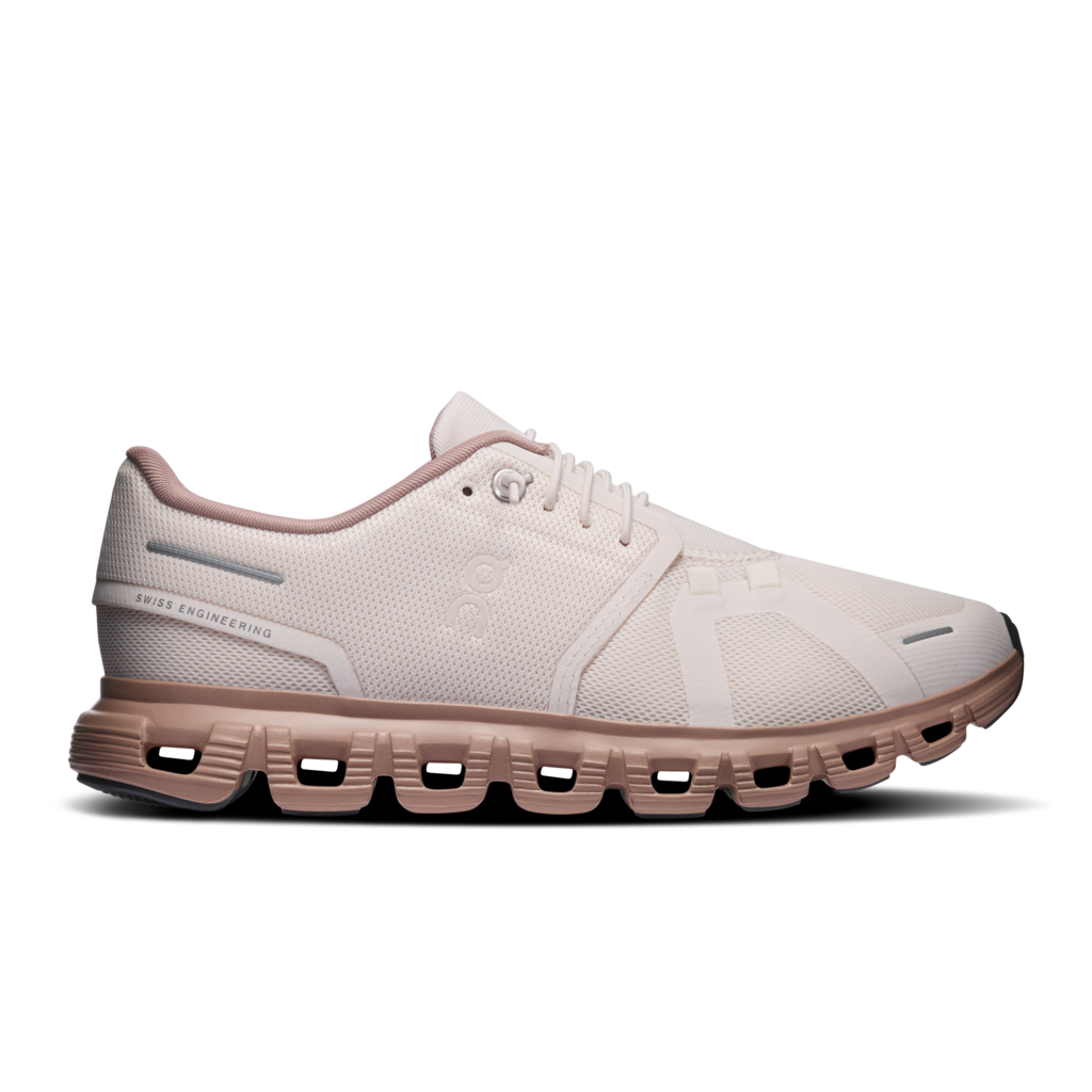 A light beige and dusty rose running shoe with a distinctive chunky, cushioned sole, shown in a side profile on a white background.