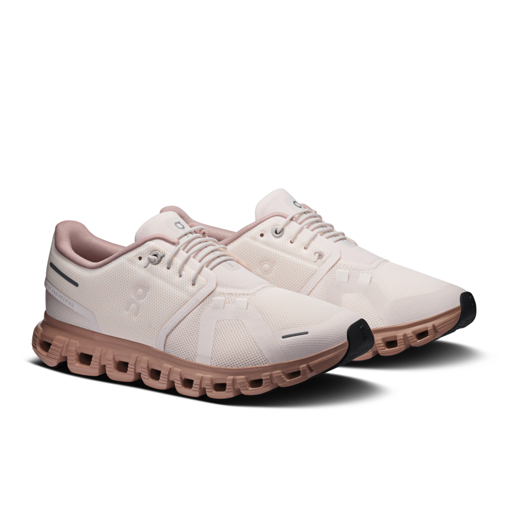 White and pink sneakers with unique sole design on a white background