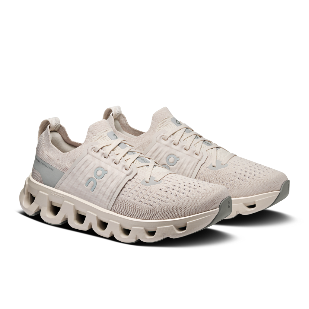 Pair of beige running shoes on a white background