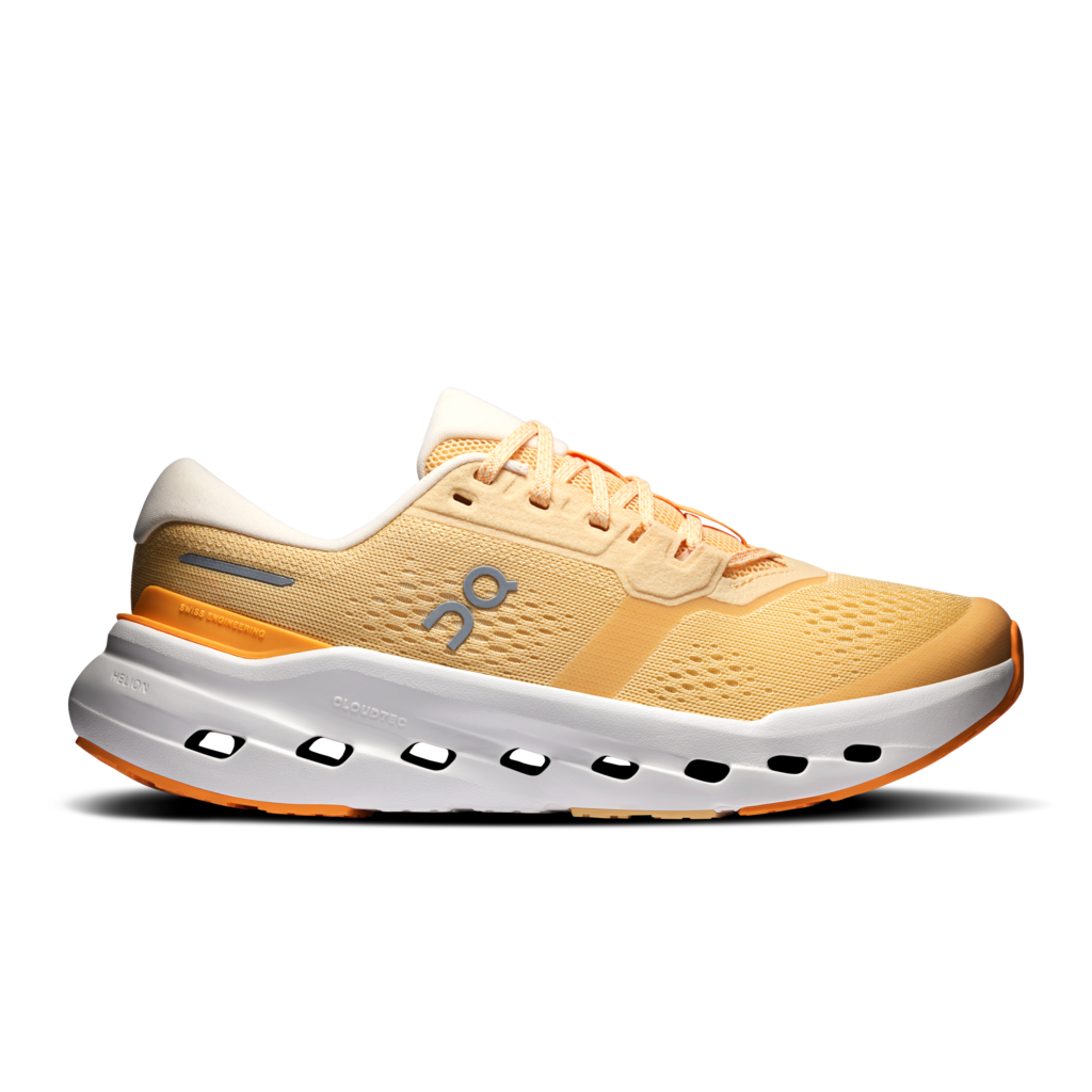 A single On running shoe in a light peach and white colorway, shown from a side profile on a clean white background. The shoe features a peach mesh upper, a white midsole with cutouts, and orange accents on the heel and outsole.