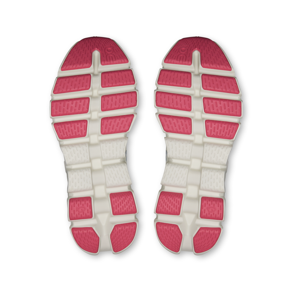 A pair of athletic shoe soles viewed from above, featuring a white textured midsole with bright pink cushioned blocks along the top and heel.