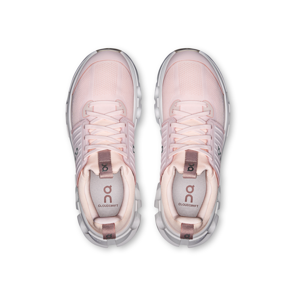 Pair of pink athletic shoes on a white background