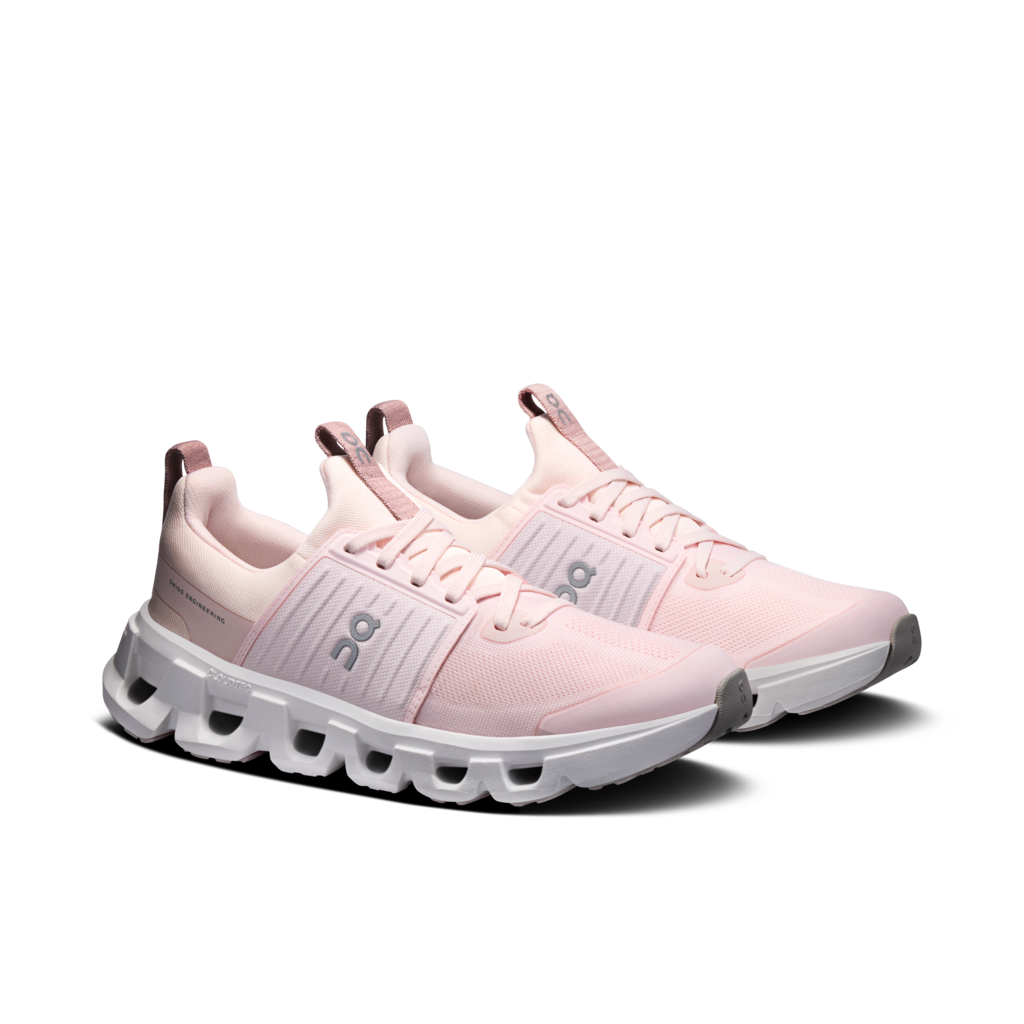 Pair of pink running shoes with white soles on a white background