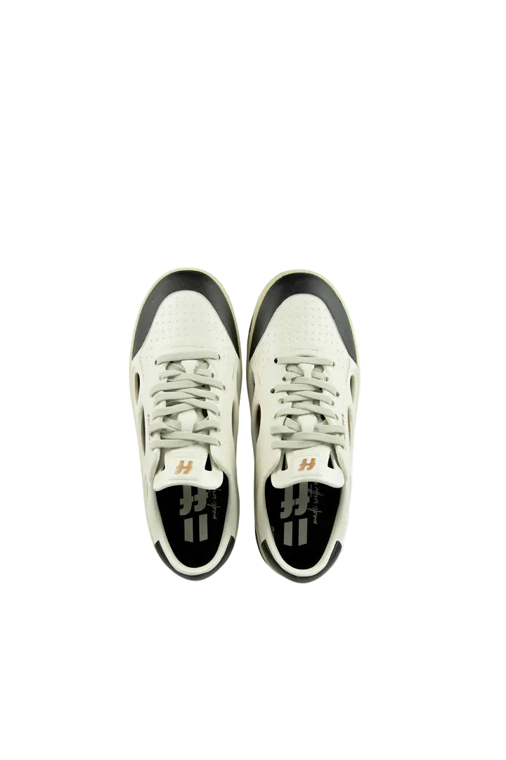 White sneakers with black soles on a white background