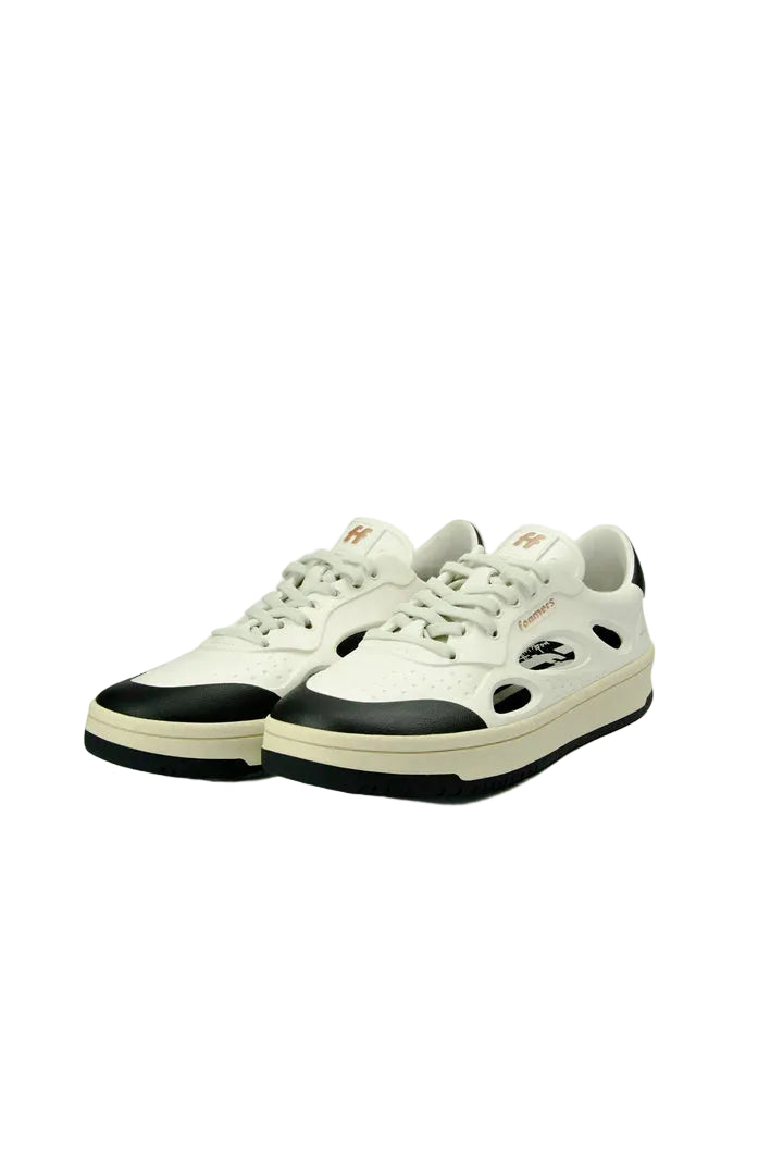 White sneakers with black soles on a white background
