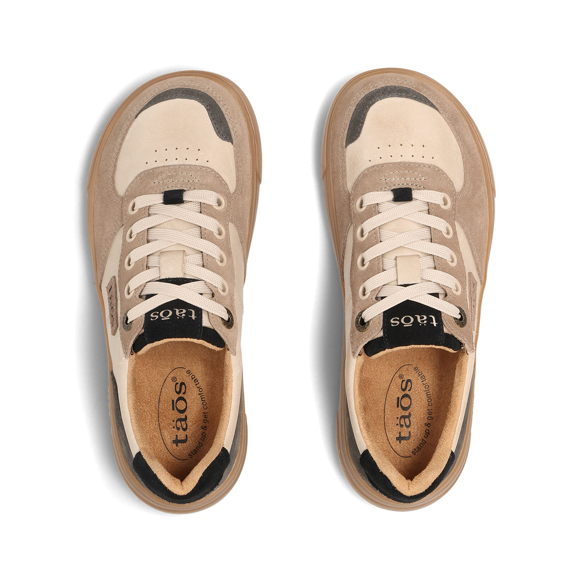 A pair of low-top sneakers shown from a top-down view on a white background. The shoes feature beige suede and cream leather panels, beige laces, black accents around the eyelets and collar, and a tan interior with the brand name 'taos' printed on the insole.