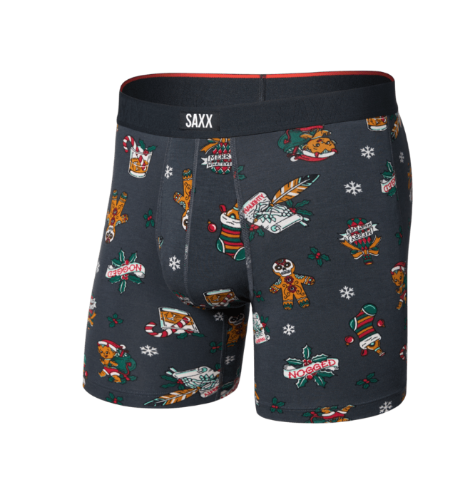 SAXX men's boxer briefs in dark gray with a festive Christmas print featuring gingerbread men, candy canes, snowflakes, and holiday sweaters, shown on a plain white background.