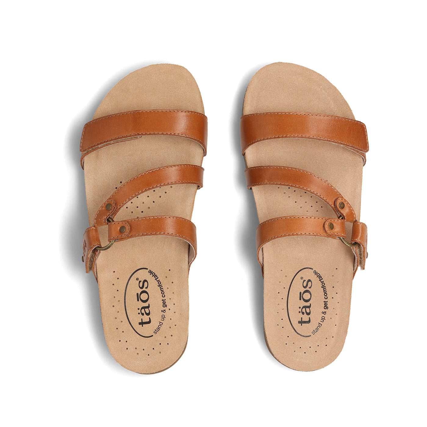 Pair of tan sandals with brown straps on a white background