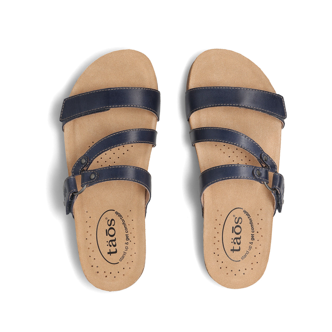 Pair of tan sandals with navy straps on a white background