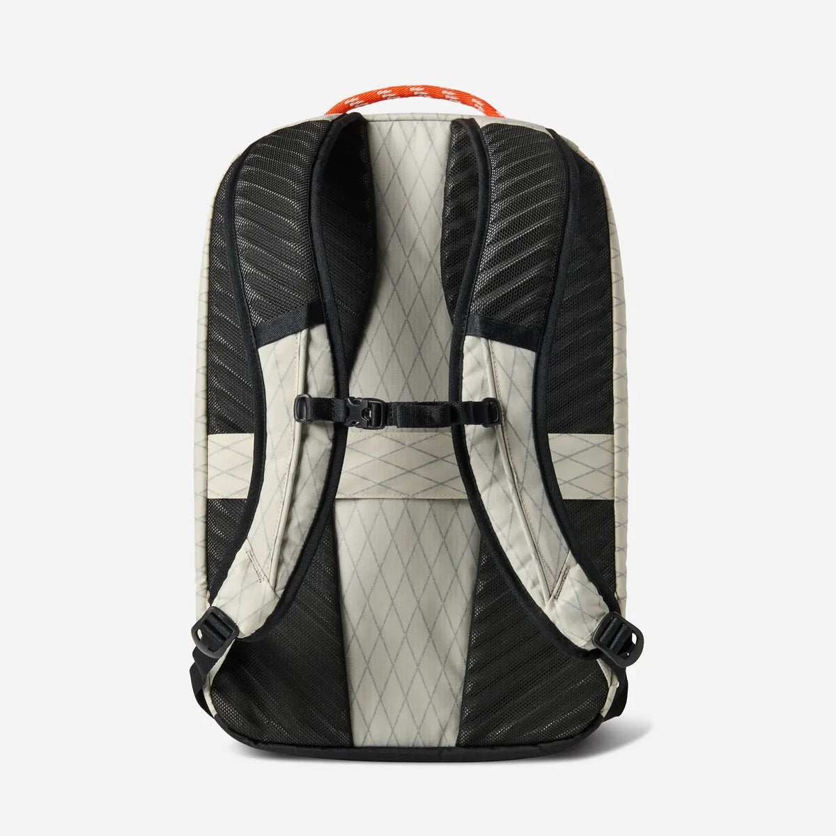 The back view of a backpack with black and light beige diamond-patterned panels, a black compression strap, and an orange top handle, shown on a light gray background.