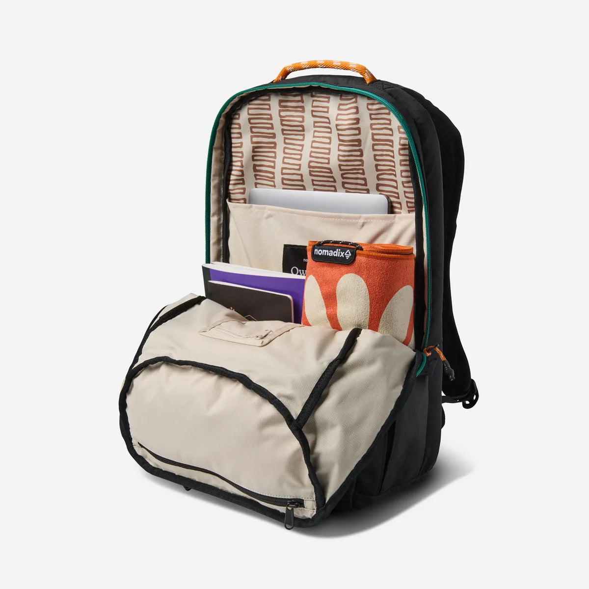 A black and beige backpack shown open, revealing its interior layout, patterned lining, and storage pockets. The backpack is styled with a laptop, notebook, and pouches inside, set against a clean, light gray background.