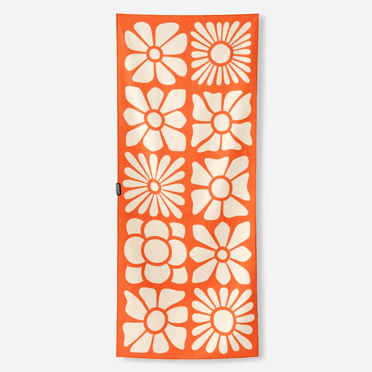 Orange towel with white floral patterns on a white background