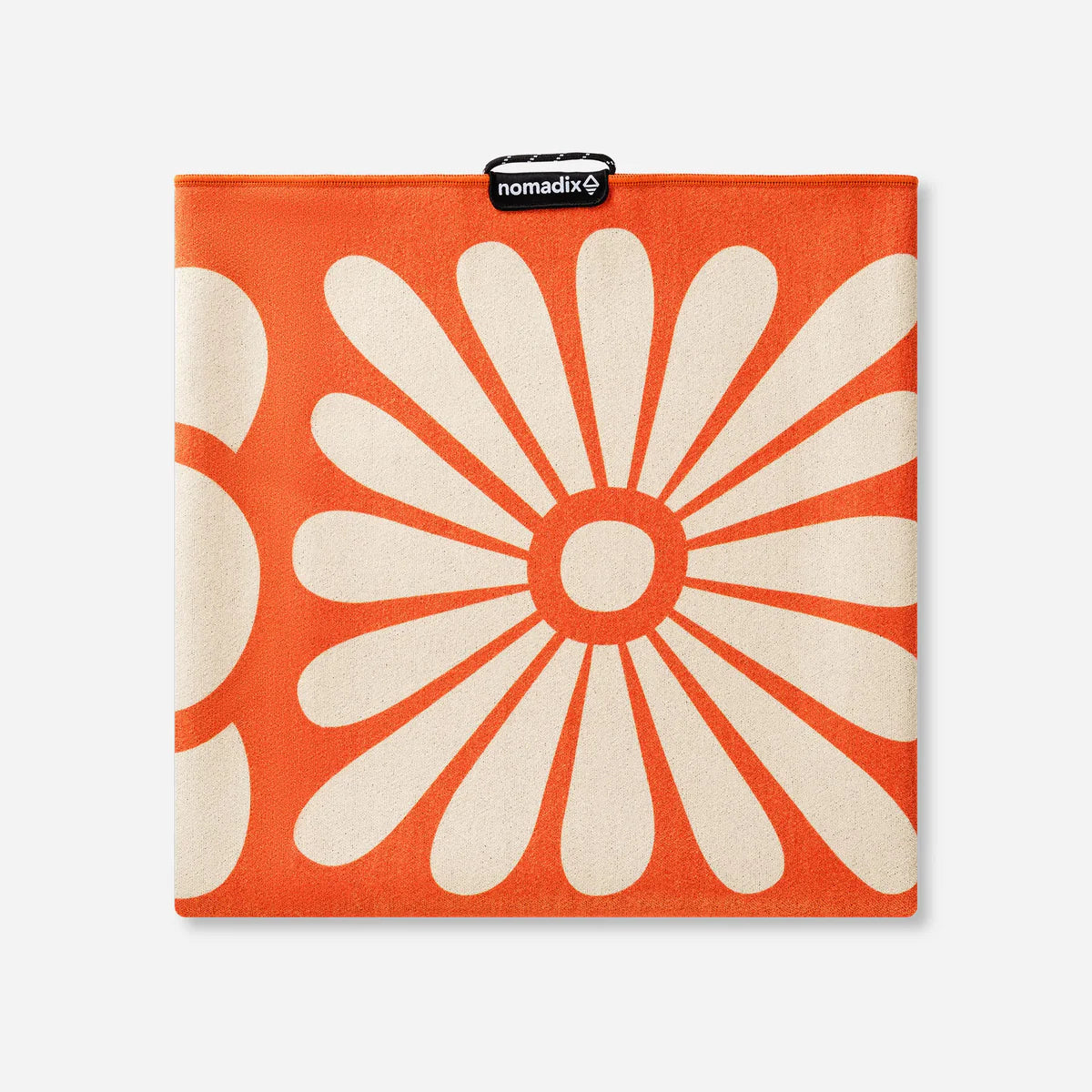 Orange and white floral patterned product with 'nomadix' branding on a white background