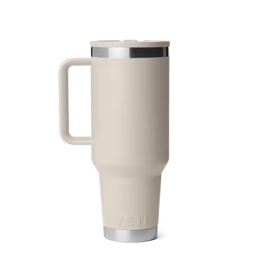 Beige travel mug with a handle on a white background