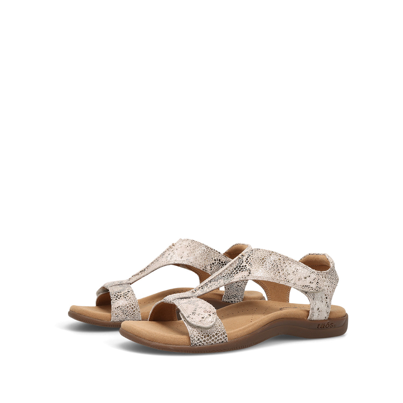 Pair of sandals with a white and brown design on a white background
