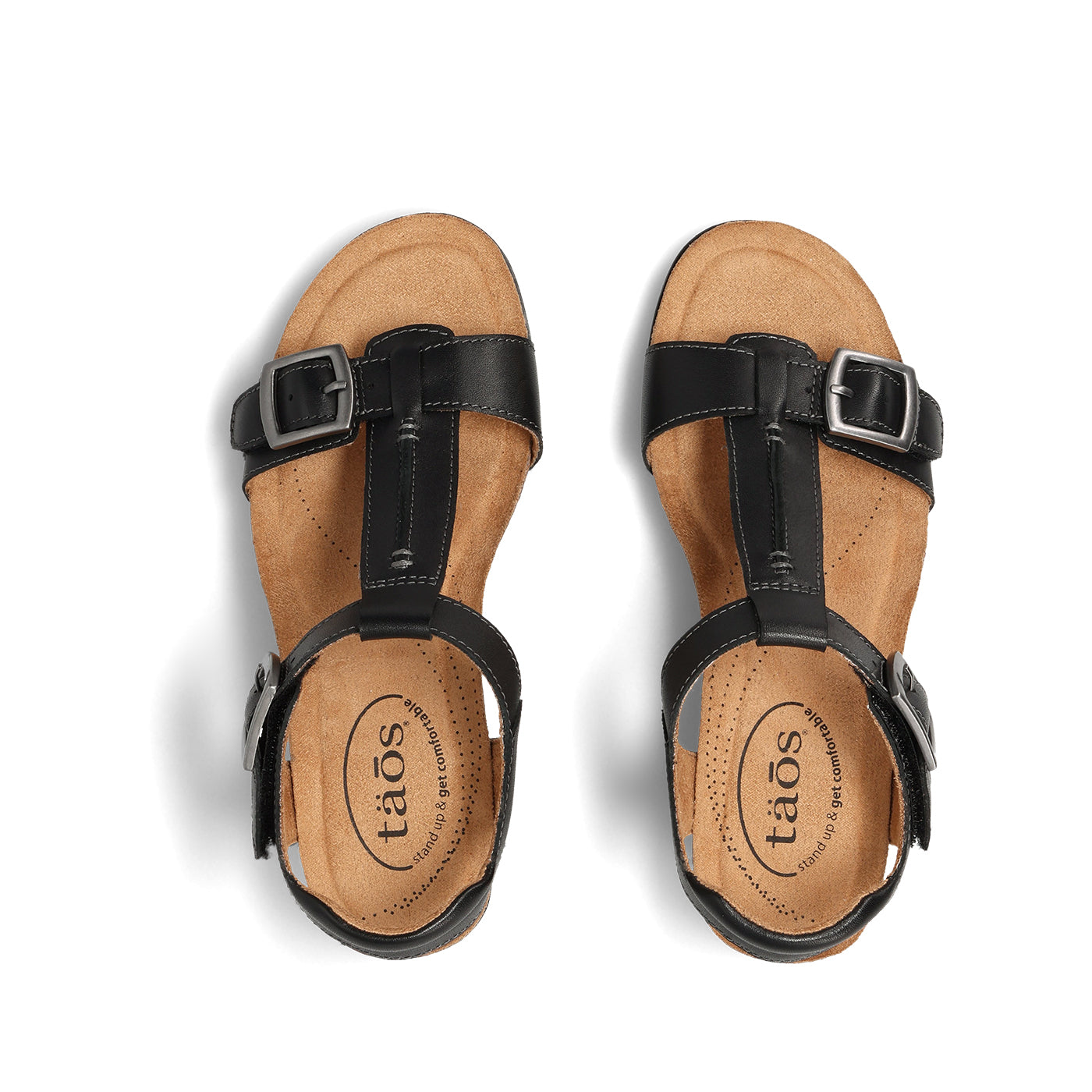 Tan sandals with black straps and 'taos' branding on a white background