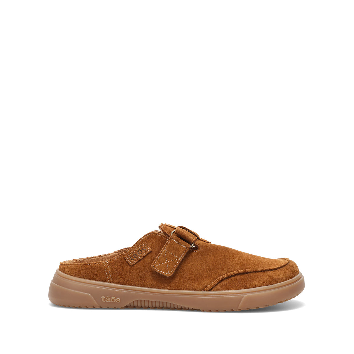 A single tan suede mule slipper with a hook-and-loop strap closure and a gum rubber sole, shown from a side profile on a white background.
