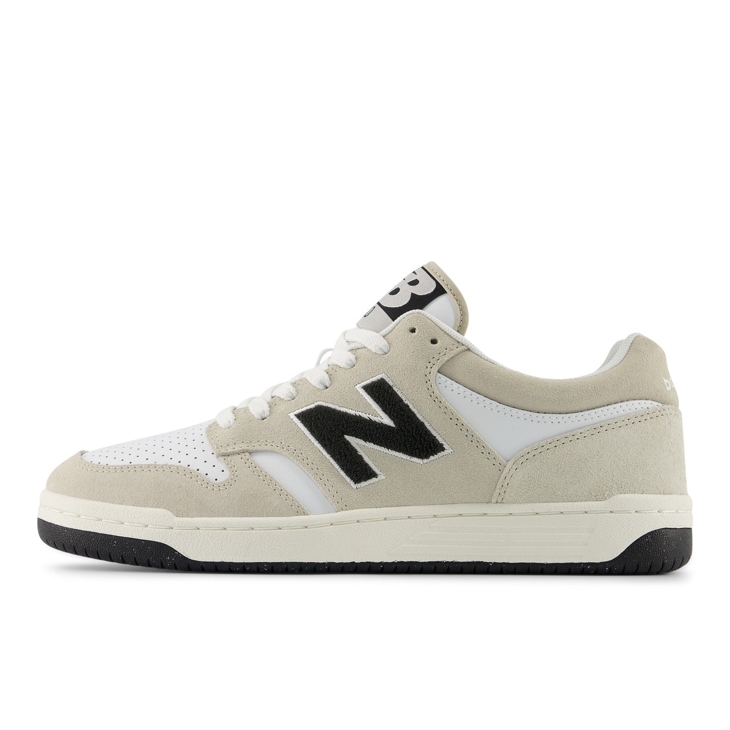 Beige sneaker with black 'N' logo on a white background