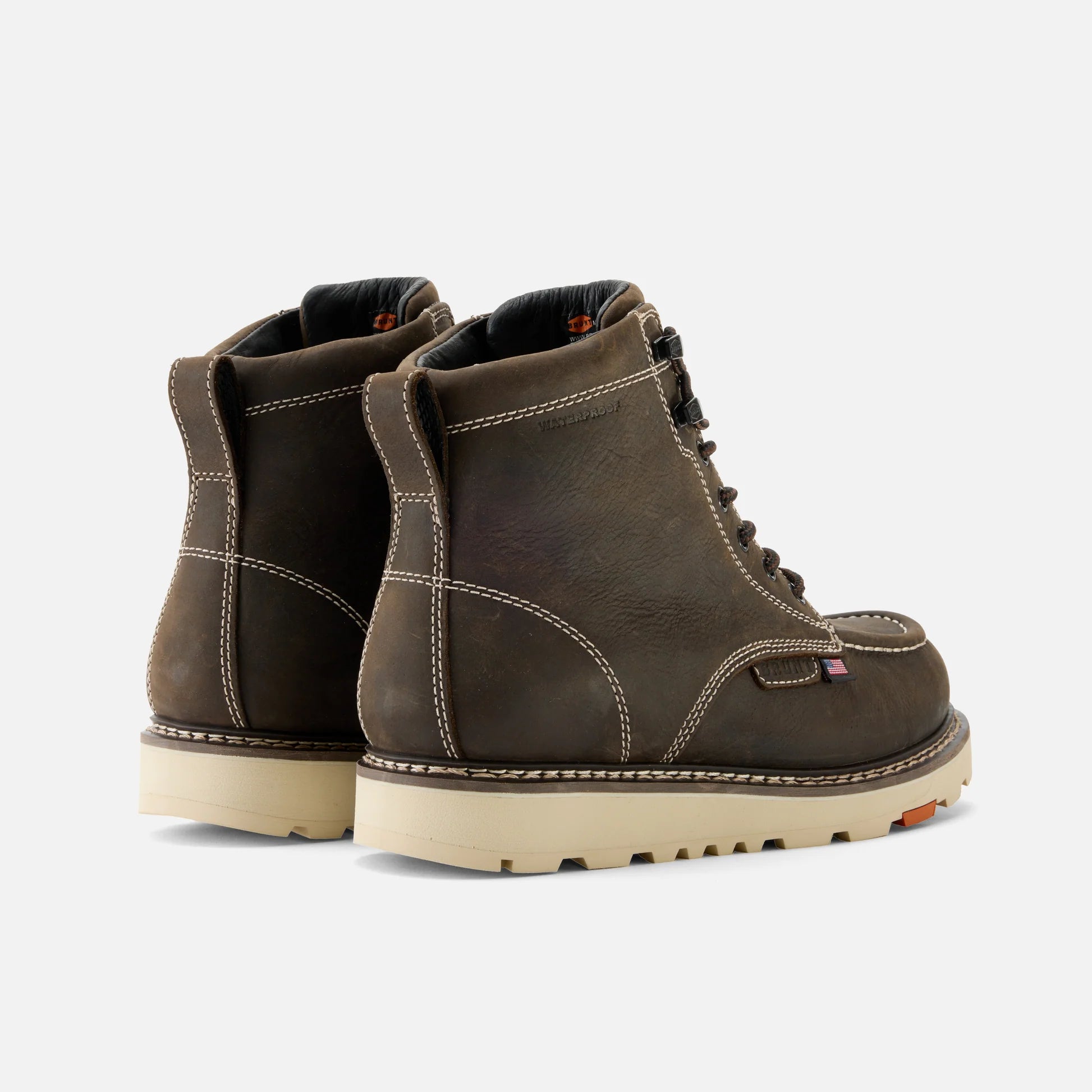 Pair of brown leather boots on a light gray background