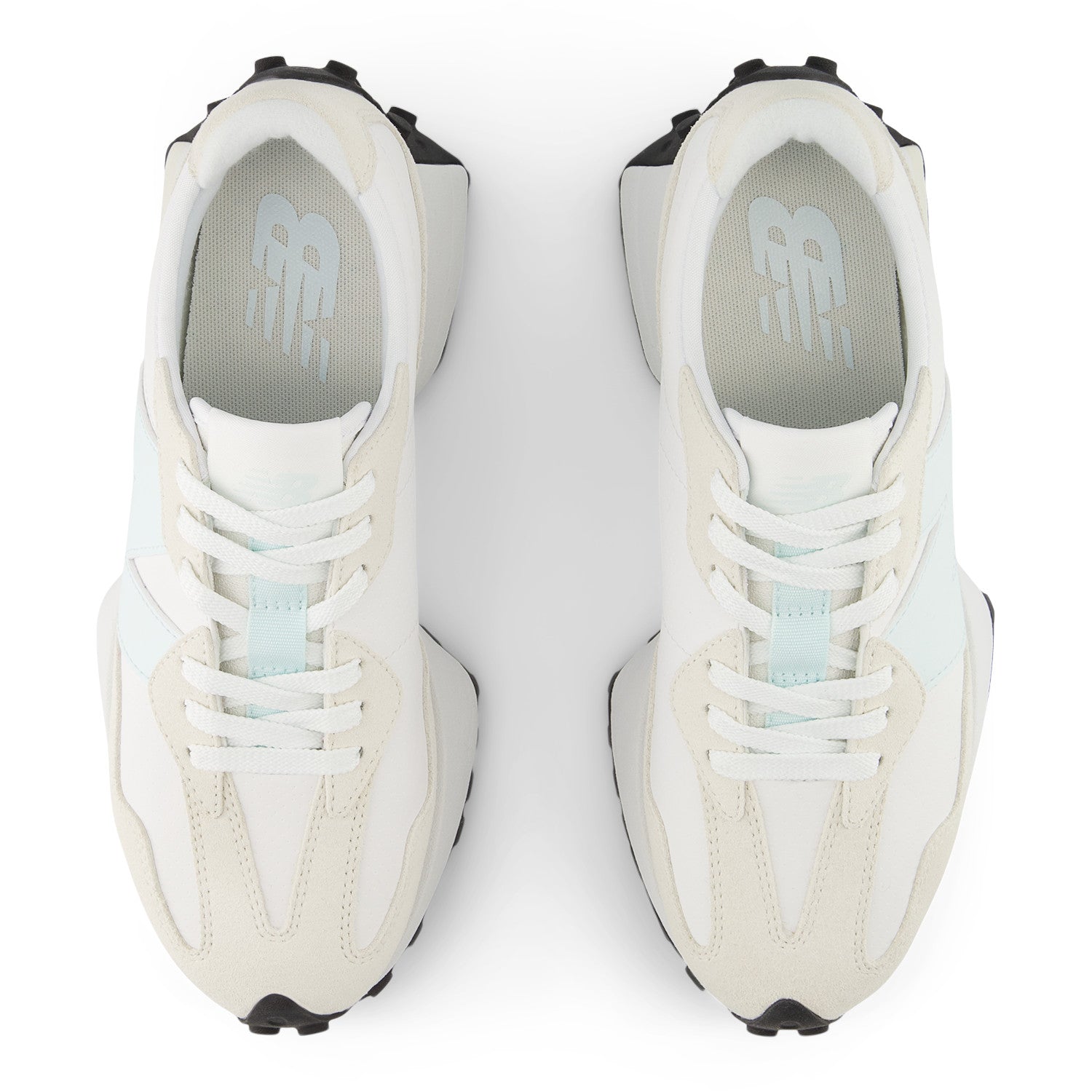 White sneakers with black soles on a white background
