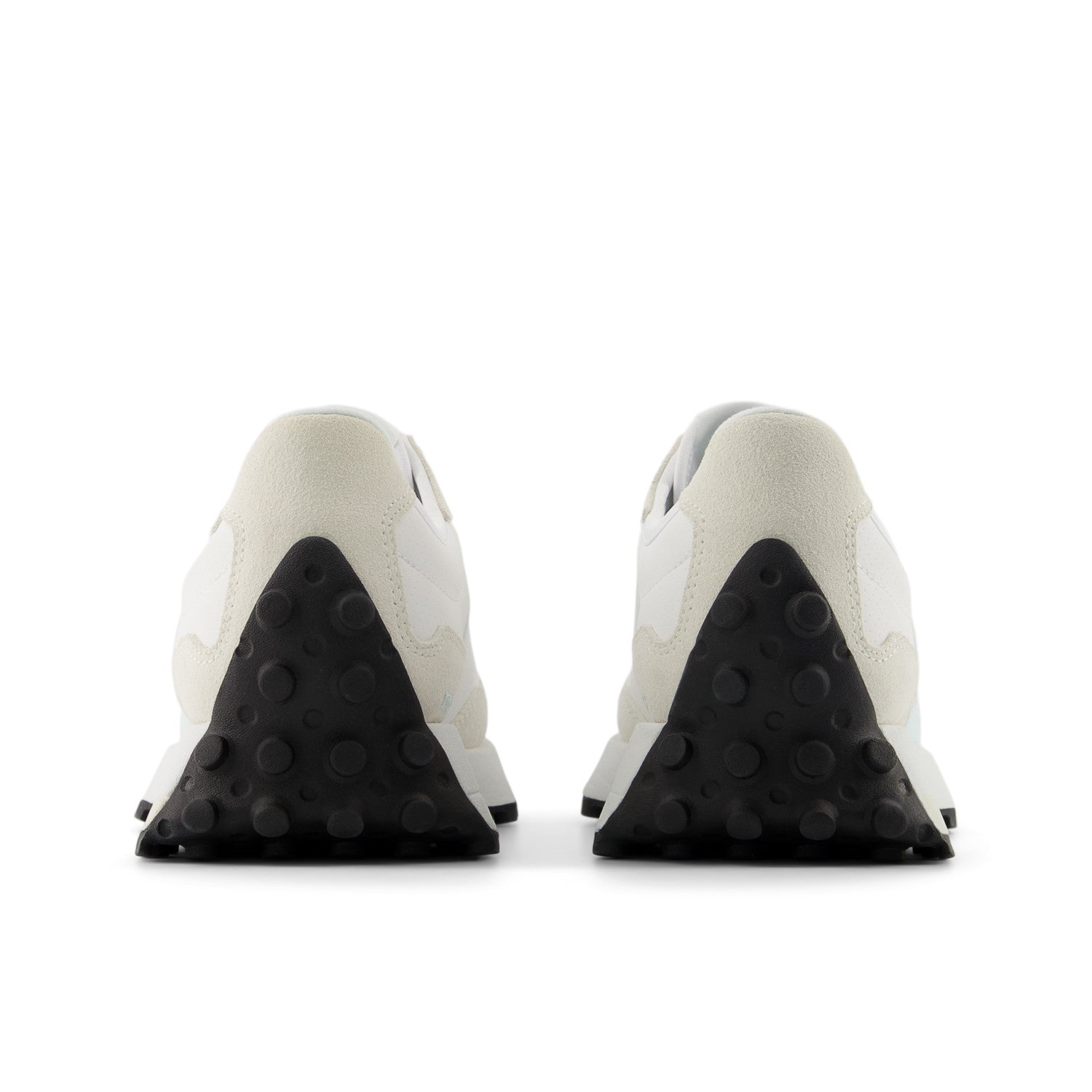 Pair of white sneakers with black sole on a white background