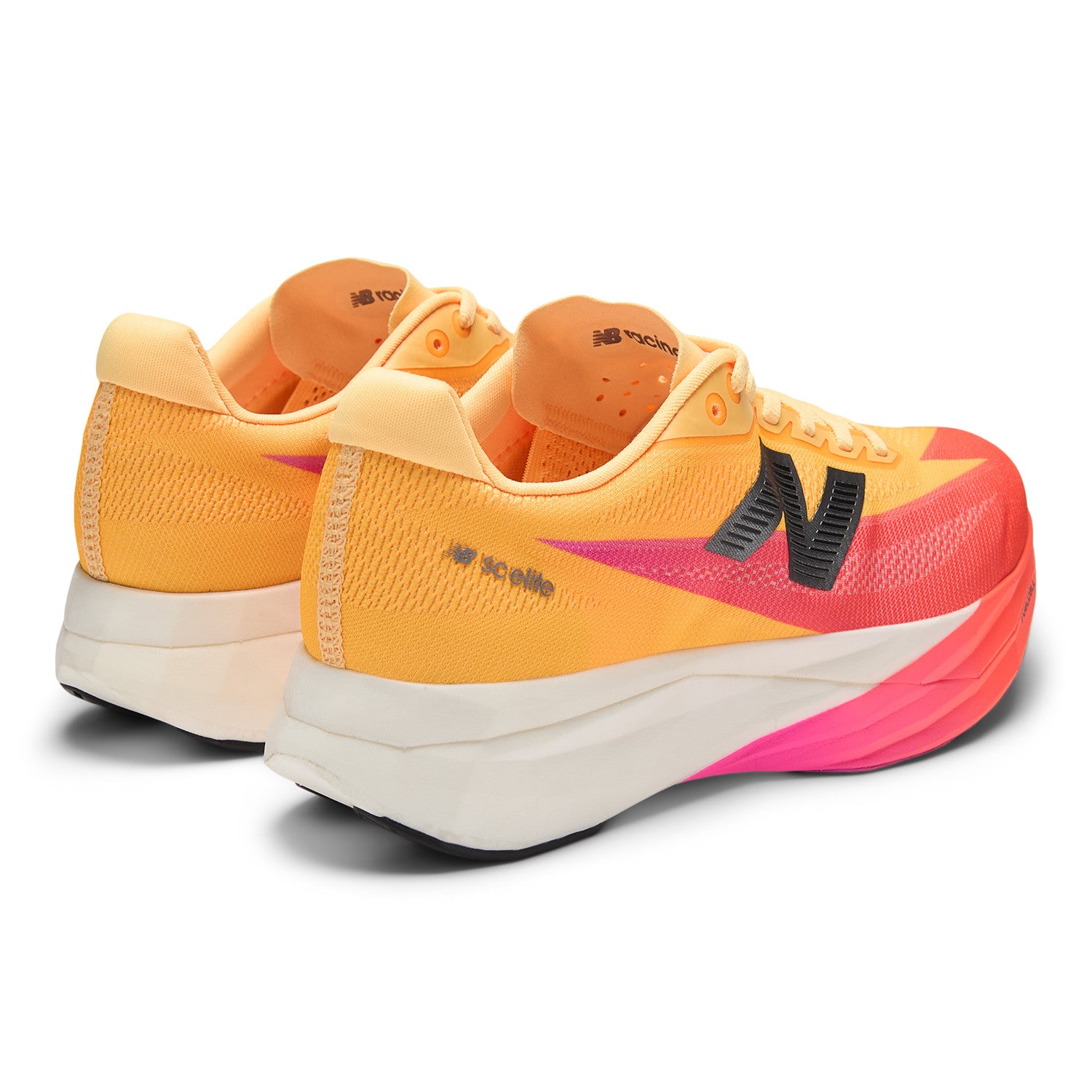 Orange and pink running shoes with New Balance logo on a white background
