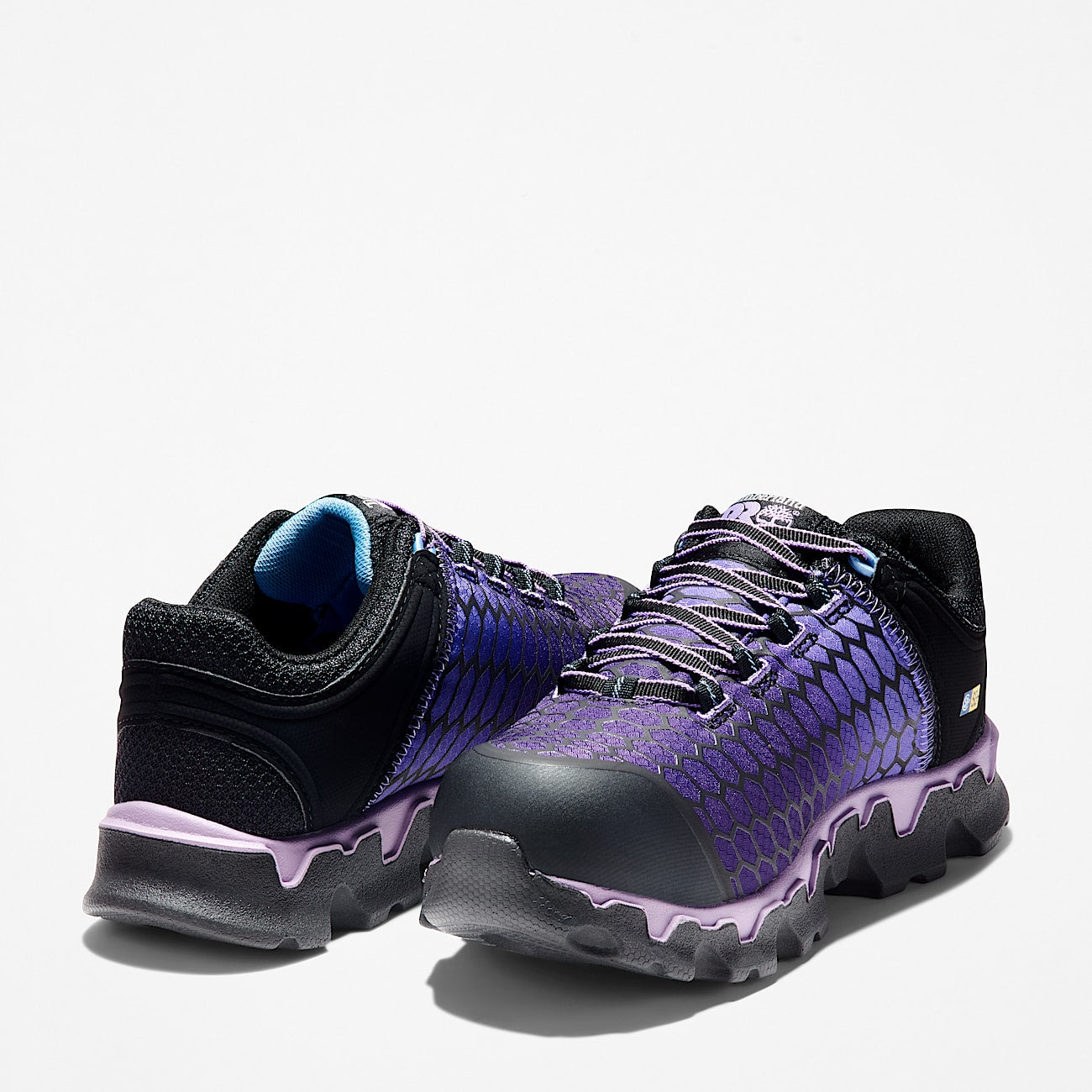 Purple and black athletic shoes on a light gray background