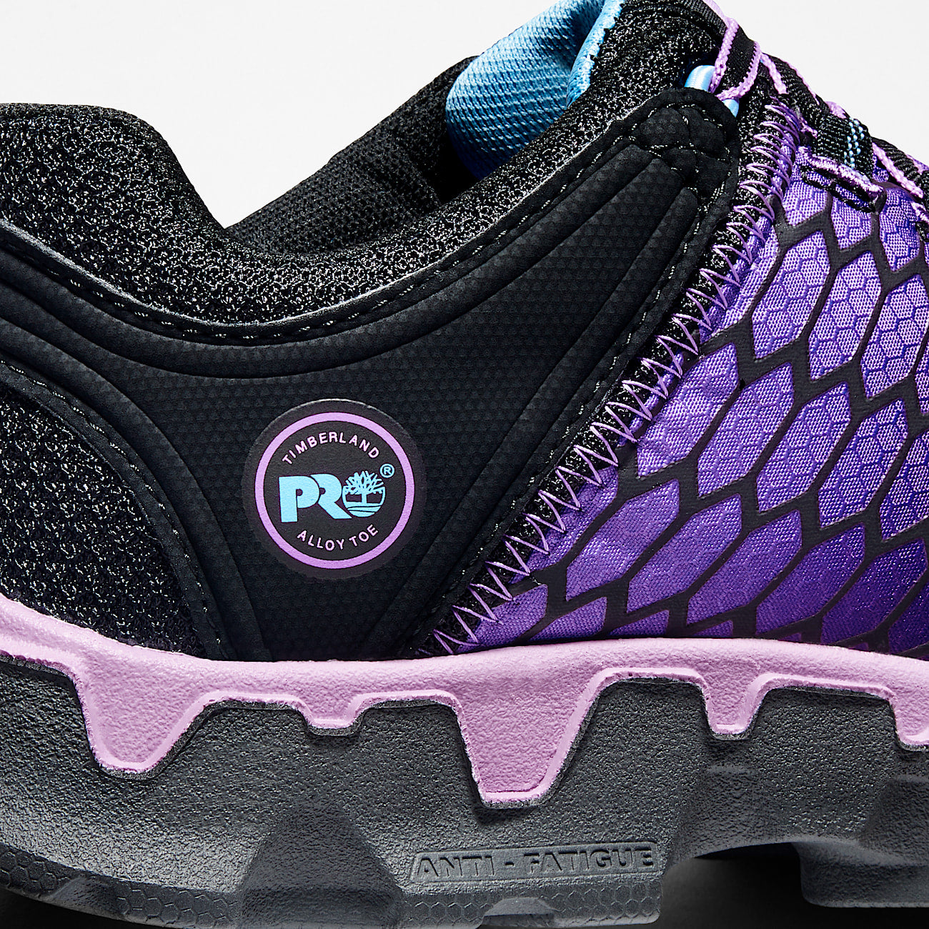 Close-up of a black and purple Timberland Pro shoe with a focus on the sole and brand logo.
