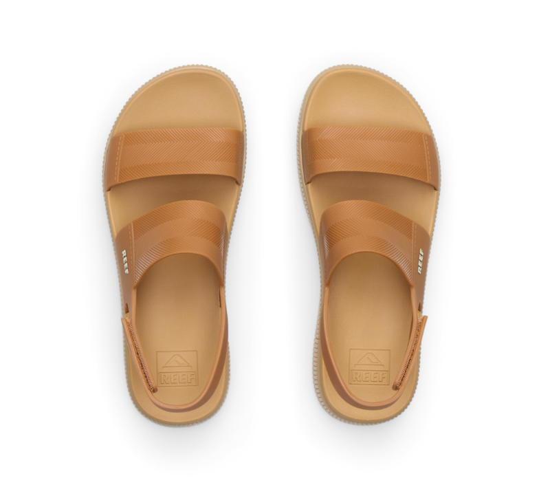 Pair of tan sandals on a white background